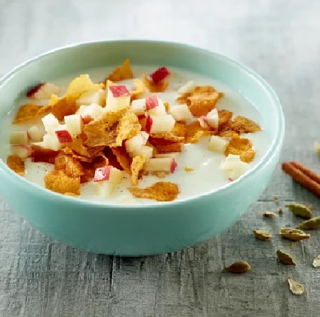 “Bowl of golden cornflakes topped with fresh fruits, served with cold milk.”